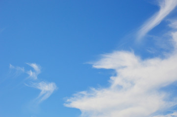 white, fluffy clouds on a background of blue sky. beauty in nature