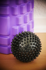 purple massage roll and a black spike massage ball