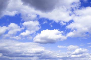 Naklejka na ściany i meble Bright blue sky with lots of fluffy white clouds
