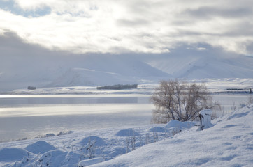 Beautiful snow scene of Lake tekapo, New Zealand. Picturesque by day and dazzling by night, Lake Tekapo is part of a UNESCO Dark Sky Reserve, making it the perfect spot for stargazing.
