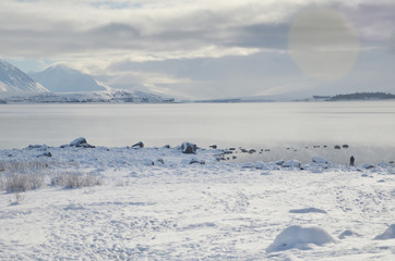 Beautiful snow scene of Lake tekapo, New Zealand. Picturesque by day and dazzling by night, Lake Tekapo is part of a UNESCO Dark Sky Reserve, making it the perfect spot for stargazing.