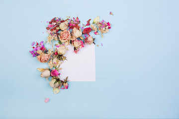 Card of flowers and leaves with paper card note. Flat lay. Nature concept