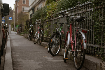 Bicycles on the sidewalk near rusty fence in Graz, Austria