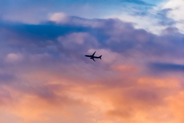 Airplane against the sky with clouds at sunset in summer (background, banner, Wallpaper, texture)