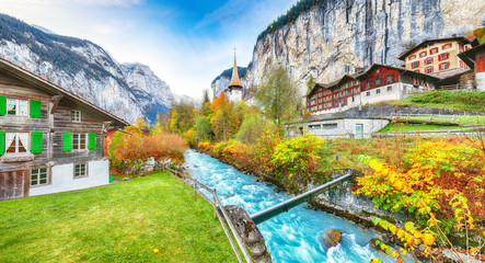Stunning autumn view of Lauterbrunnen village with awesome waterfall  Staubbach  and Swiss Alps in...