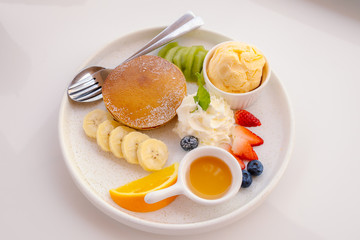 Pancake with fruits, vanilla ice cream and whipped cream