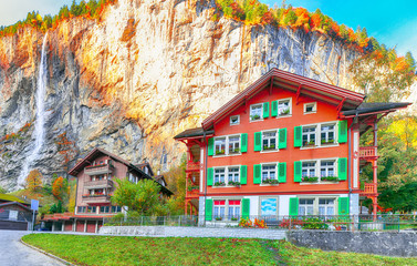 Fantastic autumn view of Lauterbrunnen village with awesome waterfall  Staubbach  in the background
