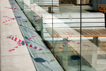 Barrier tape around the empty terraces in Rotterdam during lockdown because of the coronavirus pandemic