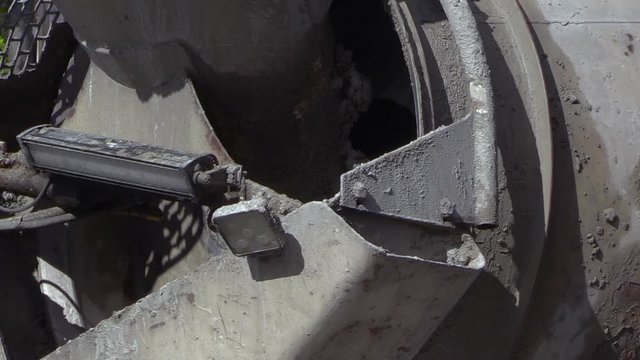 Close up of slow turning drum on a concrete mixing transport truck