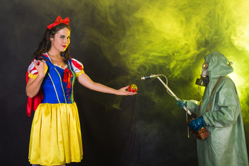 Woman wearing a fairy tale dress holding an apple with radiation symbol. Environmental problems...