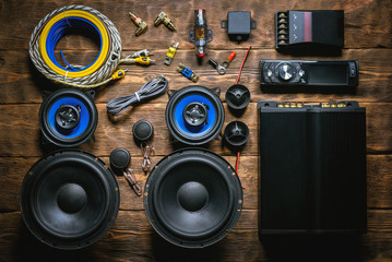 A new car audio equipment on brown wooden workbench background with copy space.