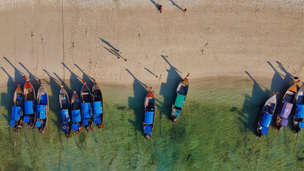 Amazing overhead aerial view of Long Tail Boats on a Thailand Beach Shoreline