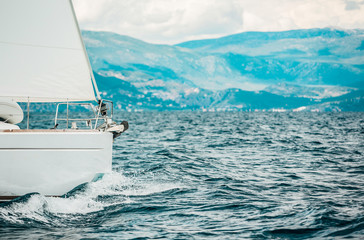 Sailing Yacht, white yacht sailing on the sea on the background of the island in Greece