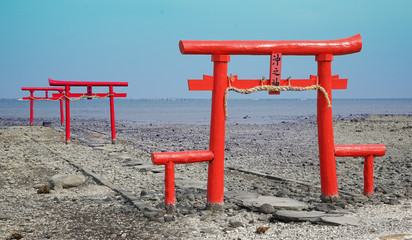 A gateway at the entrance to a Shinto shrine which there is in the Japanese sea