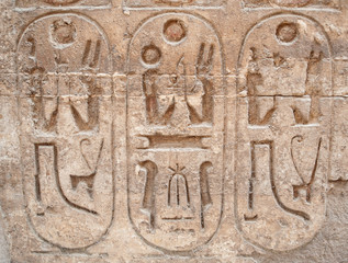 Hieroglyphic carvings on an ancient egyptian temple wall