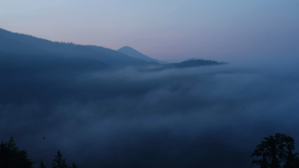 Fog over the mountains at sunrise time. Carpathian mountains