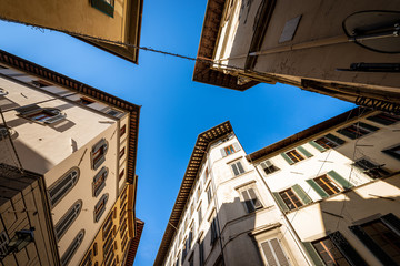 Old houses and buildings in the historic center of Florence photographed from below at a road junction. Tuscany, Italy, Europe