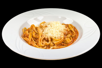 Tasty Spaghetti bolognese with tomato sauce, mince, onion, parmesan  in a white plate, isolated on black background