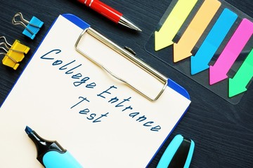 Business concept about College Entrance Test with sign on the piece of paper.
