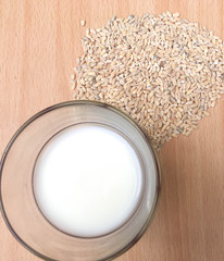 glass of milk and pearl barley porridge on a wooden table milk in a glass in the morning in the village with cereal for breakfast