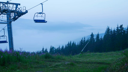 Cable car in the mountains. Ski lift in summer mountains