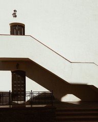 City architecture. Stairs of yellow building at the street.