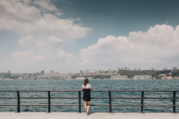 Fototapeta na wymiar young woman looking at the sea, the girl looks at the Bosphorus