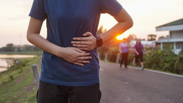 Stomach Ache Concept. Sport Injury, Stomach Ache After Running And Exercise Outside In Summer.