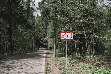 Road sign and Asphalt road in forest.