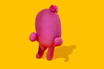 Life of rubber glove - protective wear isolated on yellow studio background with copyspace for ad. Must have during pandemic, epidemic, for protection and cleaning. Funny look from the inside.