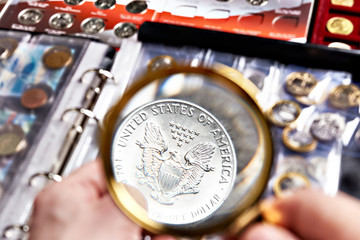 American silver dollar with magnifying glass