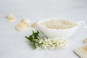 Concept of Spa-cosmetic and cosmetic procedures. Spa-sea salt in white dishes and seashells on...