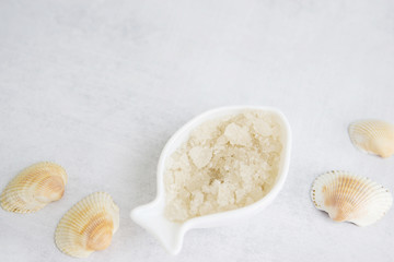 Concept of Spa-cosmetic and cosmetic procedures. Spa-sea salt in white dishes and seashells on...