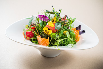 fresh salad with fish and edible flowers