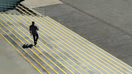 man walking down concrete steps outside