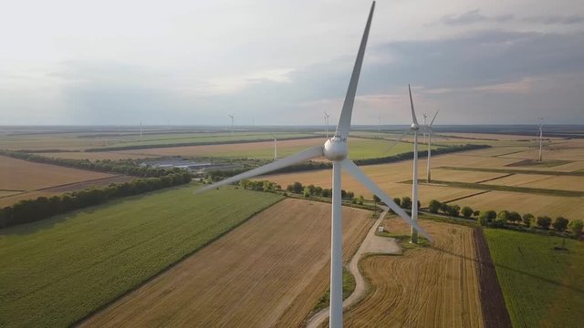 Aerial view of wind turbine generators in field producing clean ecological electricity.