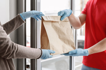 Contactless transfer parcel. Client and delivery man in gloves, protects from virus during quarantine