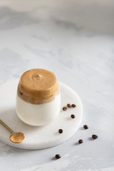 Dalgona coffee. Iced fluffy creamy whipped trendy drink with coffee foam and milk. Trendy drink during Covid-19 city lock down and self quarantine, stay at home concept.