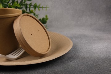 A set of eco-friendly utensils with green leaves on a concrete background. The concept of eco-friendly utensils. Copy space.Close-up.