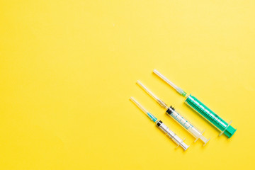 Top view of medical syringes on colorful background with copy space. Injection equipment concept