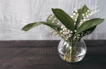 Bouquet of the lily of the valley in glass vase