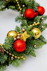 elements of winter wreath of pine needles decoration red and golden Christmas toys