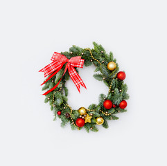 Fototapeta na wymiar Winter wreath of pine needles decoration red and golden Christmas toys