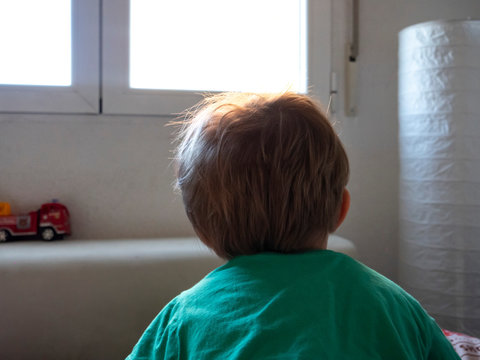 Boy Looking Out The Window With White Background