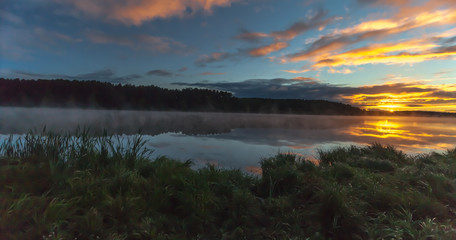 Summer dawn on a pond with fog