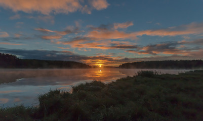 Summer dawn on a pond with fog