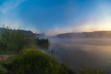Fototapeta na wymiar Mist over the lake dawn early morning in the summer