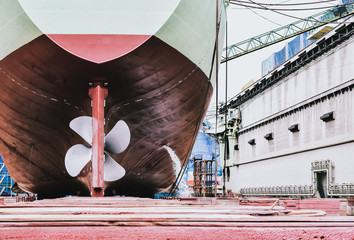 Detail of black stern and ship propeller, rudder in shipyard after maintenance already by surveyor...