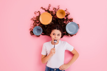 Top view above high angle flat lay flatlay lie concept portrait of her she nice attractive beautiful wavy-haired girl licking spoon dishes meal isolated over pink pastel color background