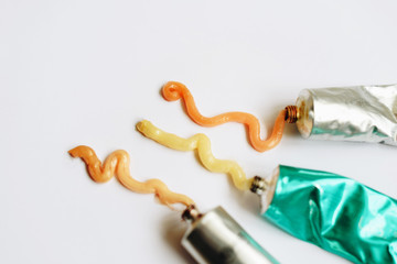 Squeezed out tubes of hair dye on a white background